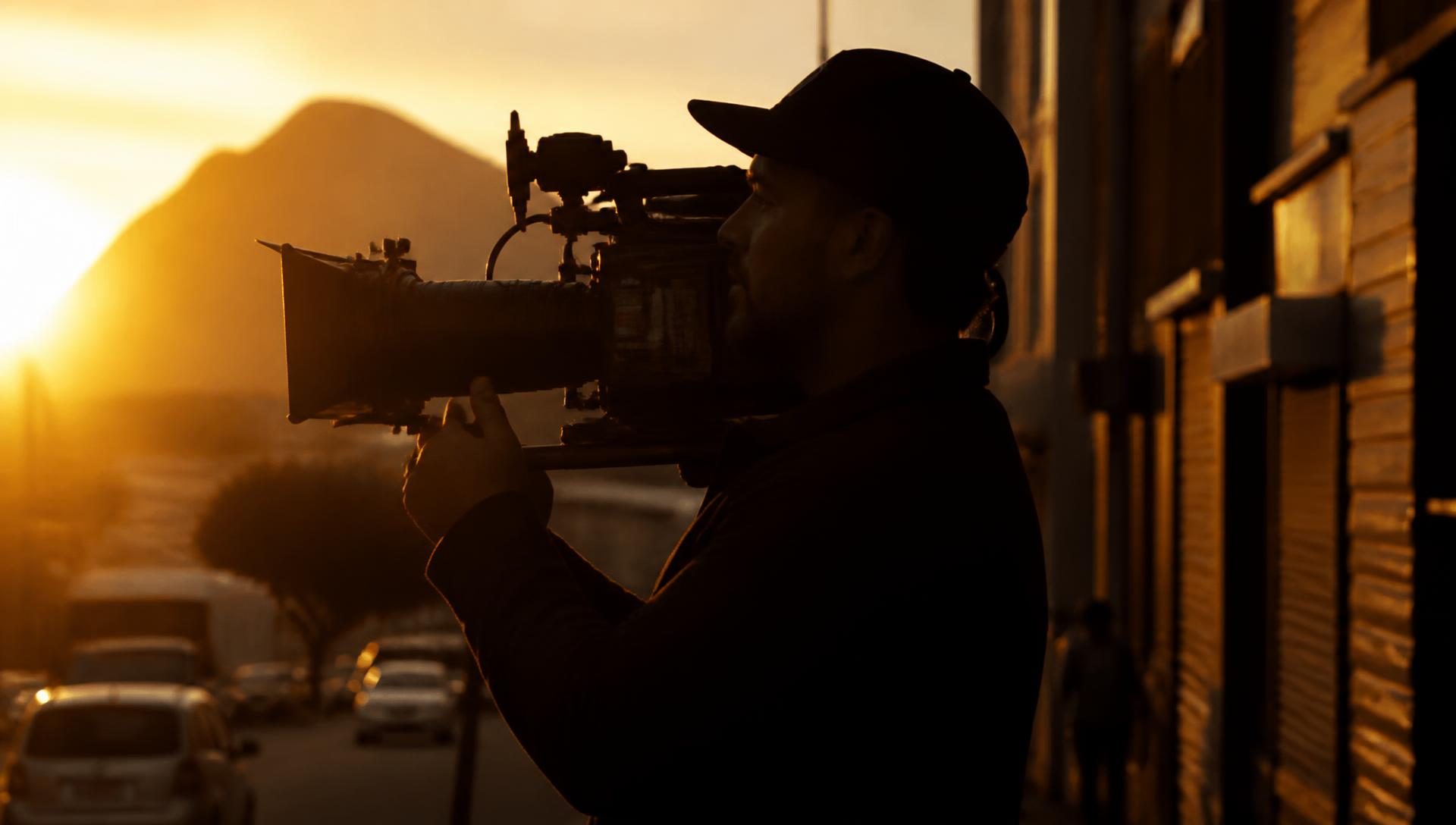 Filmmaker shooting on a Cape Town street at golden hour